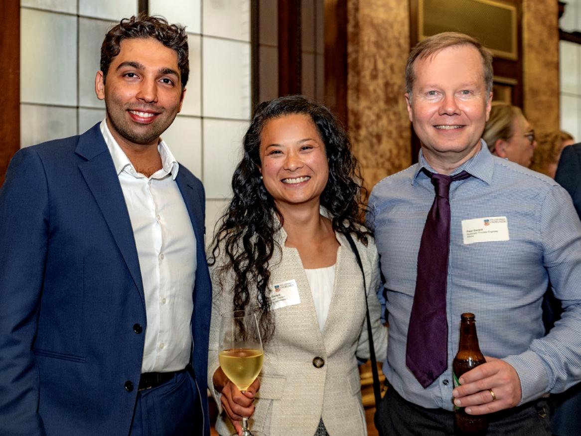 Three alumni together at the celebration in London