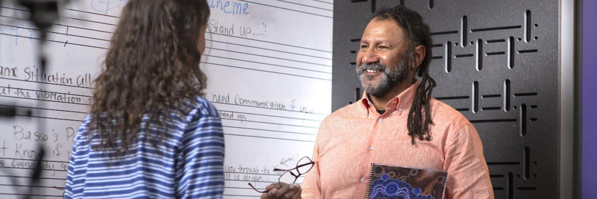 Grayson Rotumah from CASM with a student