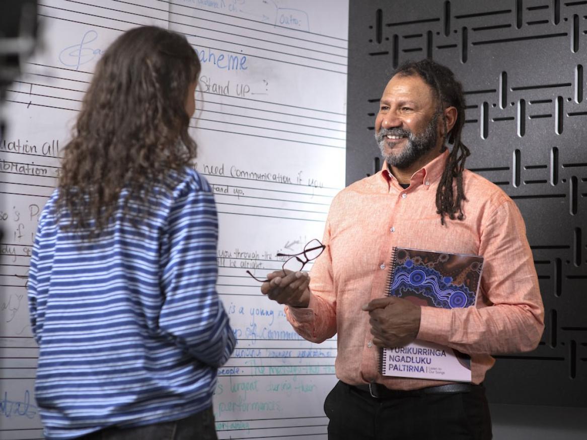 Grayson Rotumah from CASM with a student