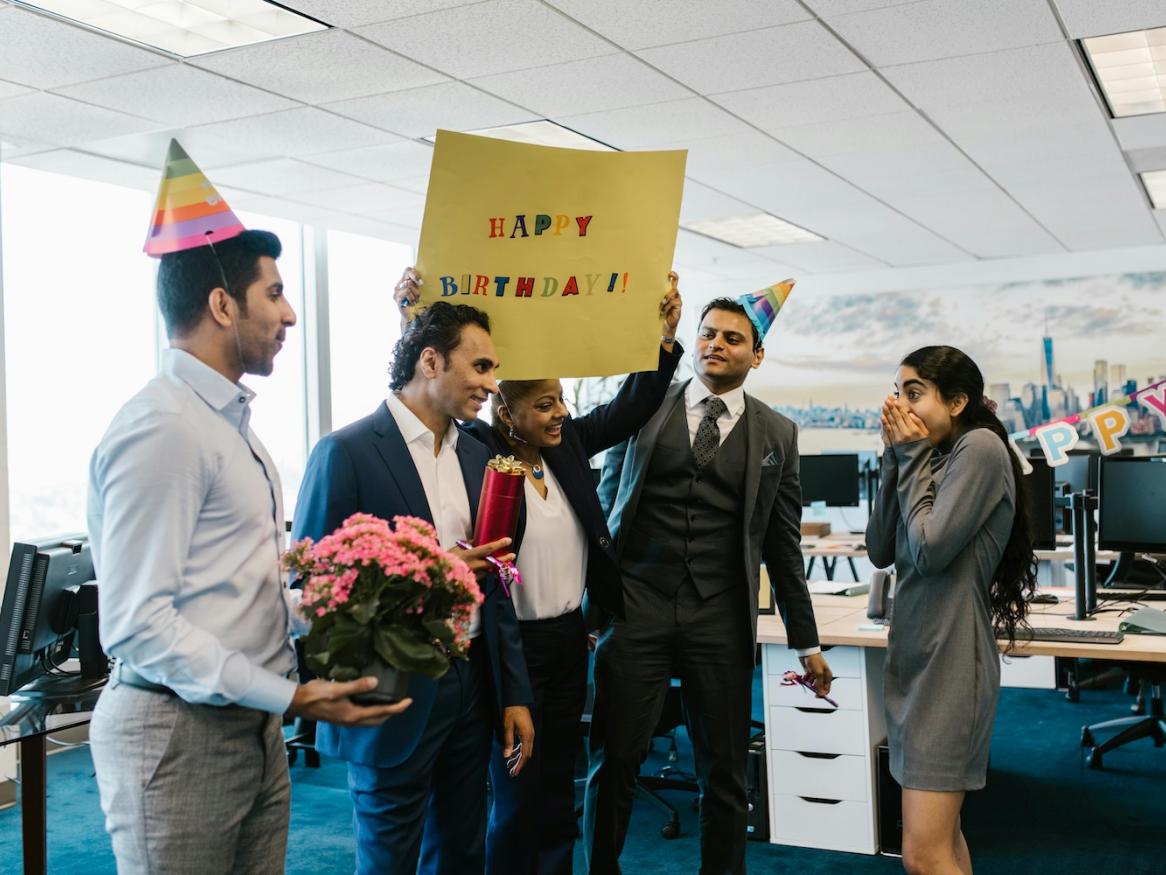 Co-workers celebrating a birthday together.