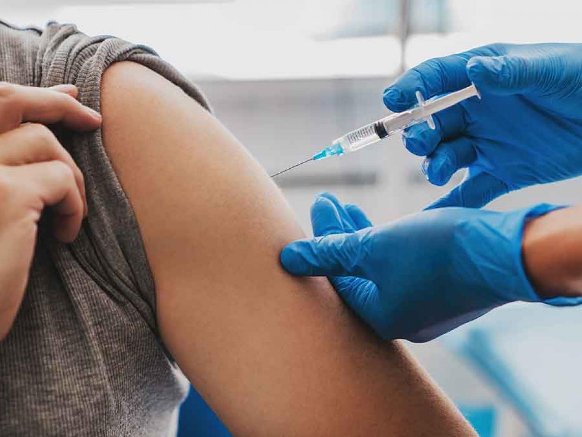 A vaccine being administered into someone's arm